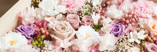 close up of roses and chrysanthemums and other mixed blooms in white, peach, pink and purple for how to preserve flowers at home