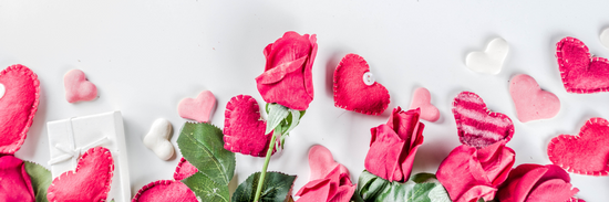 image of pink roses and pink and white heart balloons against a white background for valentine's day flowers for delivery