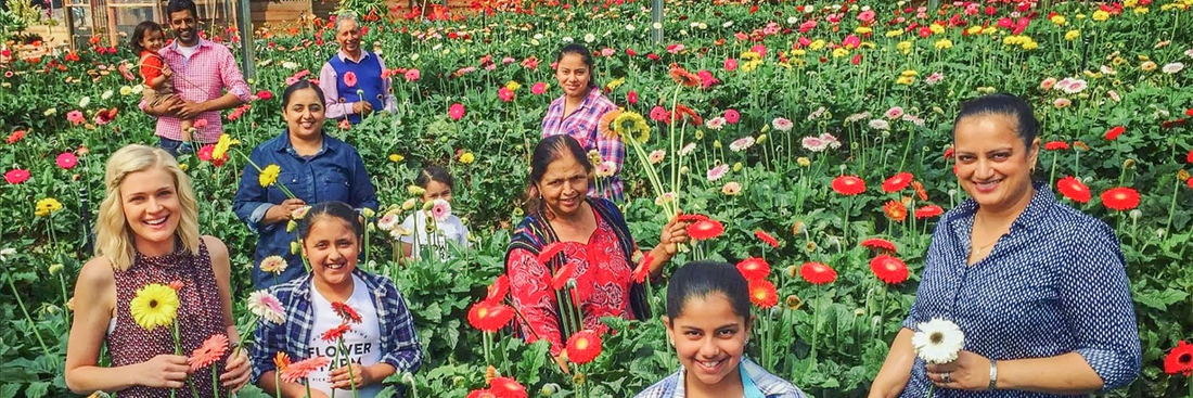 image of flower farm family and friends in the field of flowers each holding a beautifully coloured locally grown flower